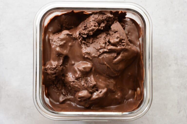 Vegan dark chocolate ice cream in a glass container.