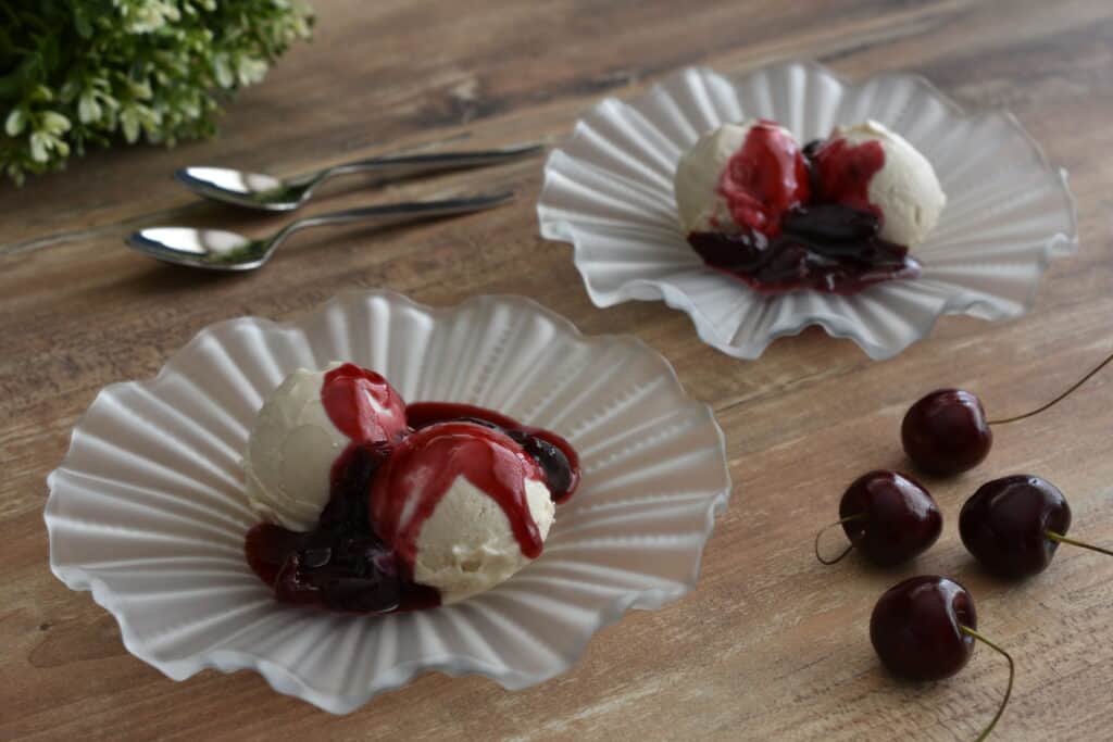 Vegan vanilla ice cream and cherry sauce