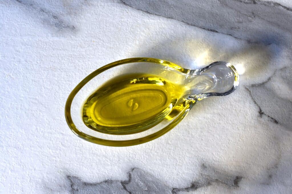 Extra virgin olive oil in glass dish.