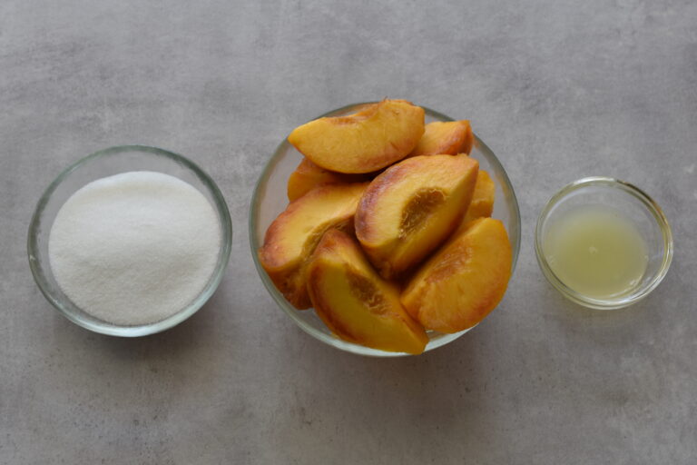 Peach quarters, sugar and lemon juice (ingredients for peach sorbet)