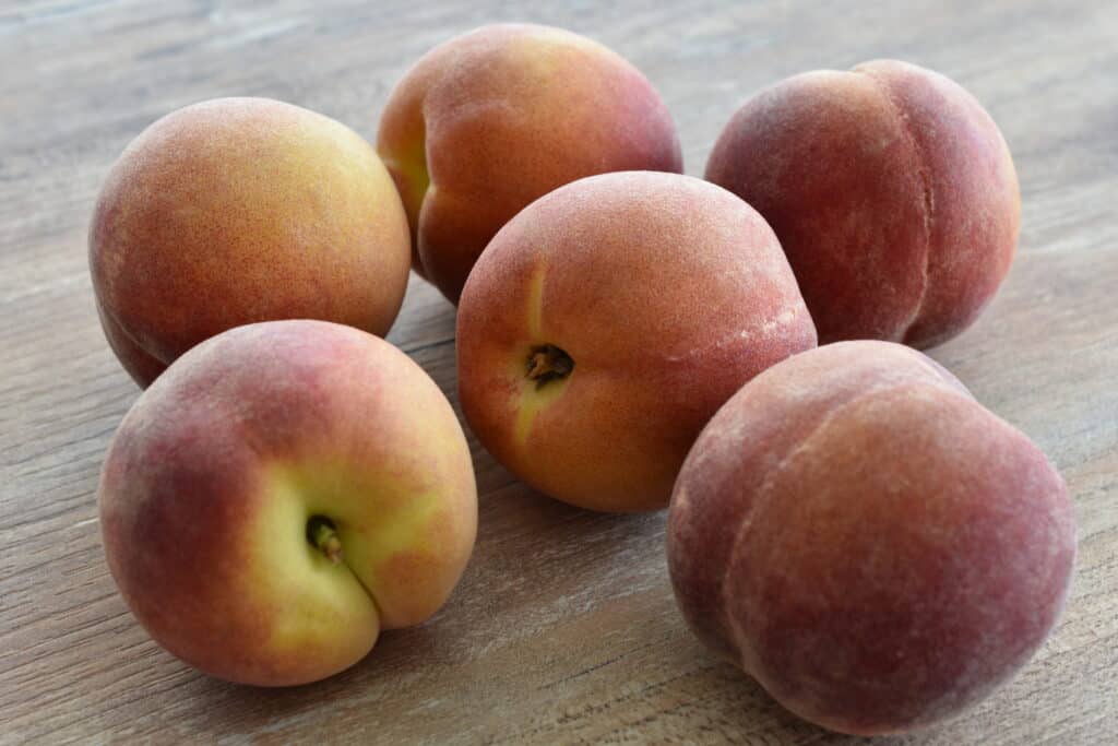 Peaches on a wooden table.