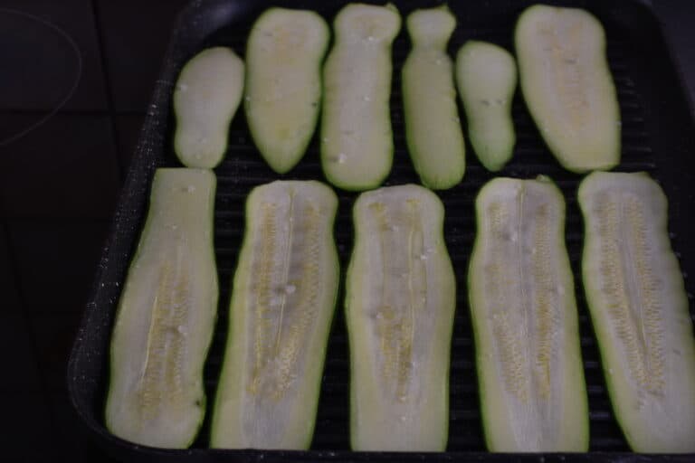 Slices of courgettes (zucchini) on a grill pan.