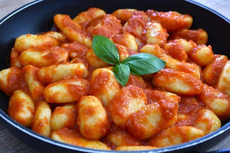 A pan of potato gnocchi with homemade fresh tomato sauce.