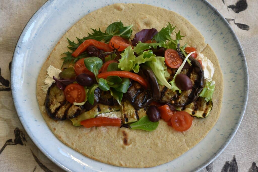 A farro piadina on a plate with a vegan filling.