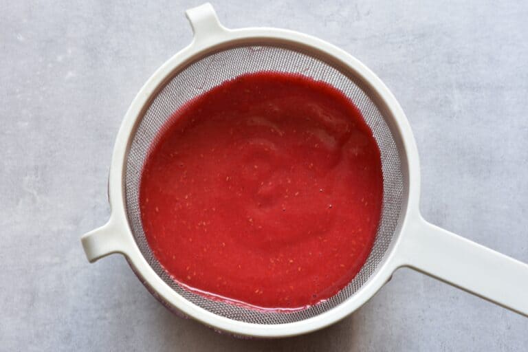 Strain the raspberry sorbet mixture through a sieve.