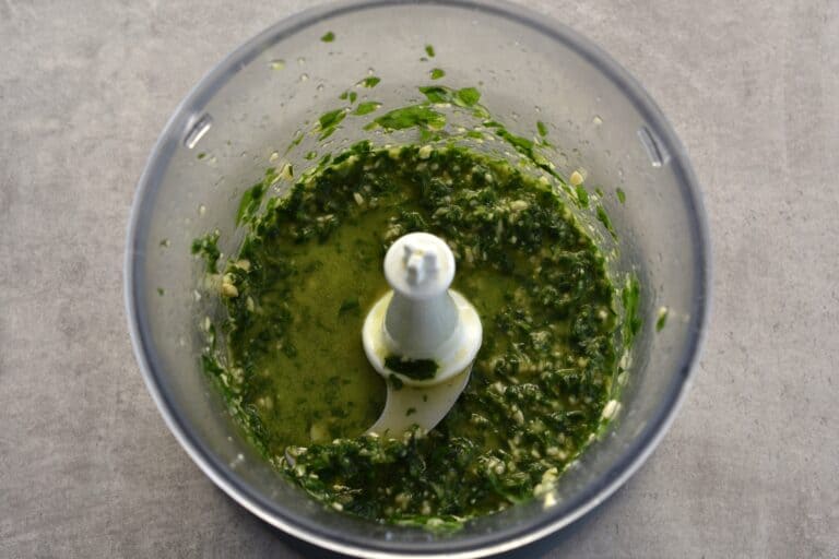 Basil leaves ground in a food processor with pine nuts., oil, garlic, lemon juice, and salt.