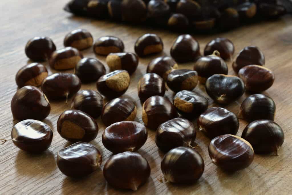 Chestnuts on a wooden table.