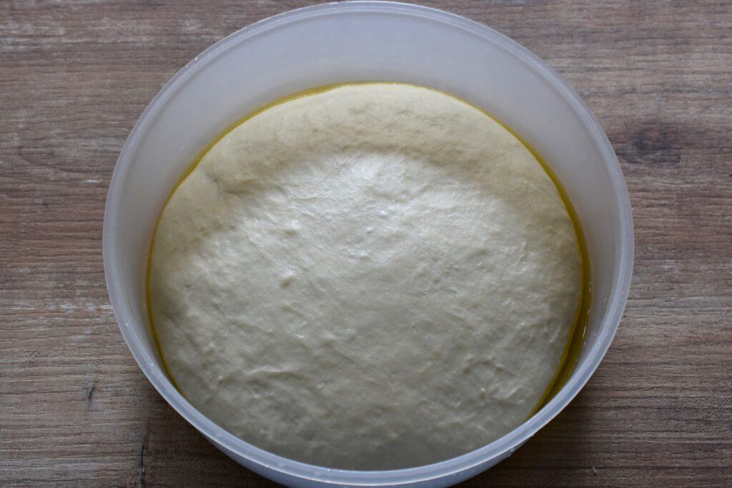 Focaccia dough in a bowl after the first dough rise.