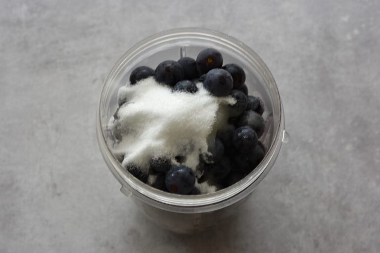 Grapes, sugar and lemon juice in a blender beaker.