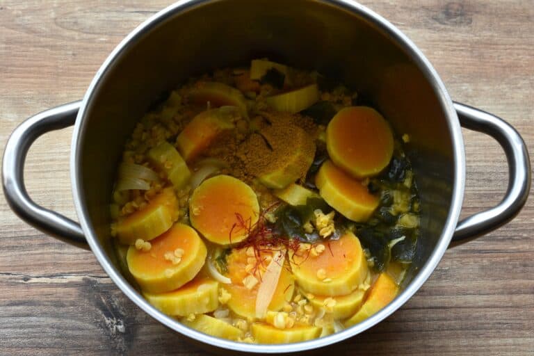 Pumpkin and red lentil soup ingredients in a saucepan ready to be blended.