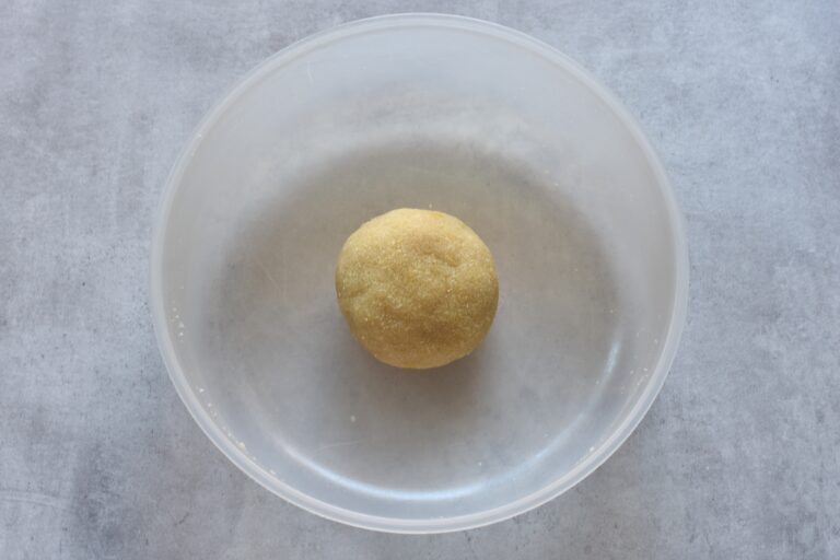 A ball of vegan Italian almond cookie paste in a bowl.