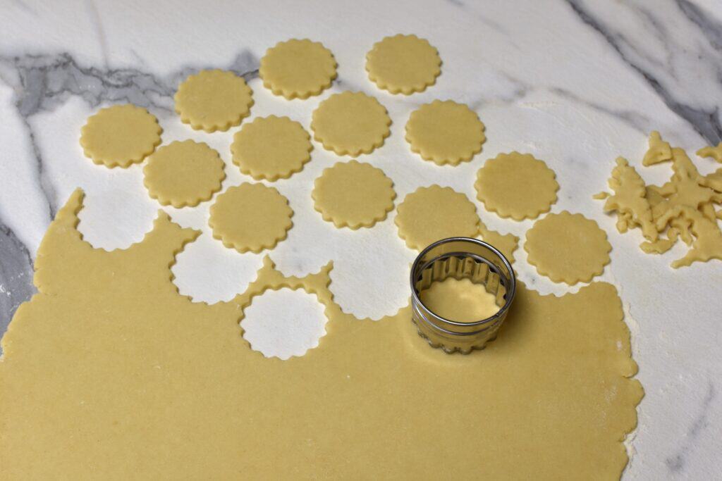 Cutting out biscuits with a biscuit cutter.