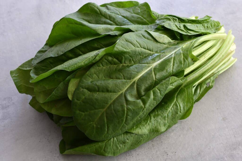 Italian erbette (perpetual spinach) leaves on a worktop.