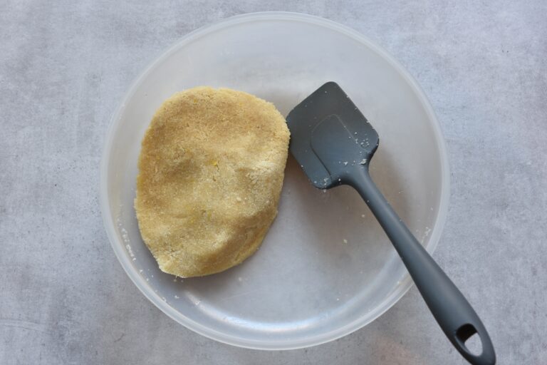 Vegan Italian almond biscuit paste in a plastic bowl.