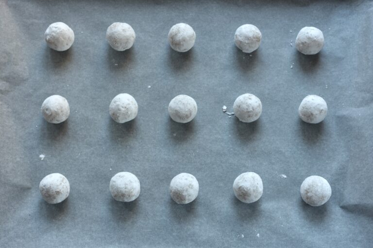 Vegan Italian almond biscuit balls on an oven tray.