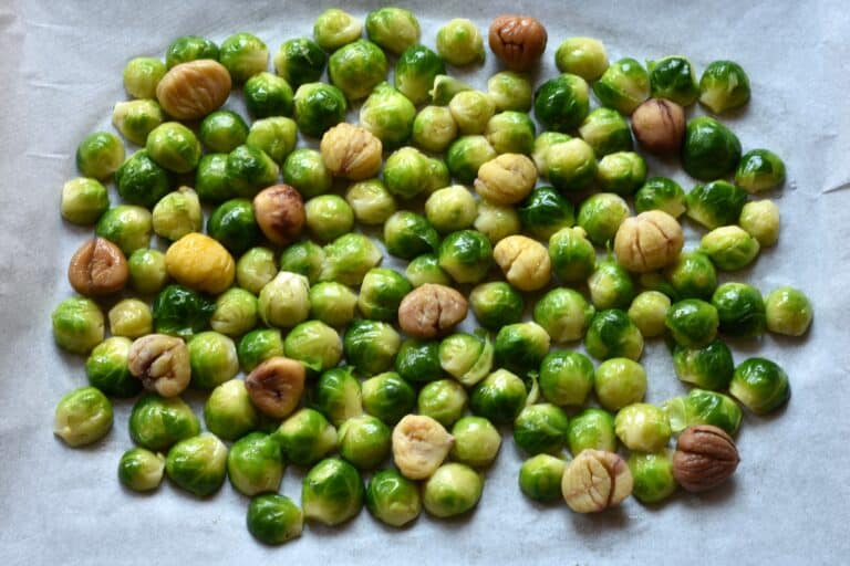 Brussels sprouts and chestnuts on an oven tray.