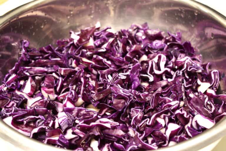 Raw sliced red cabbage in a colander.