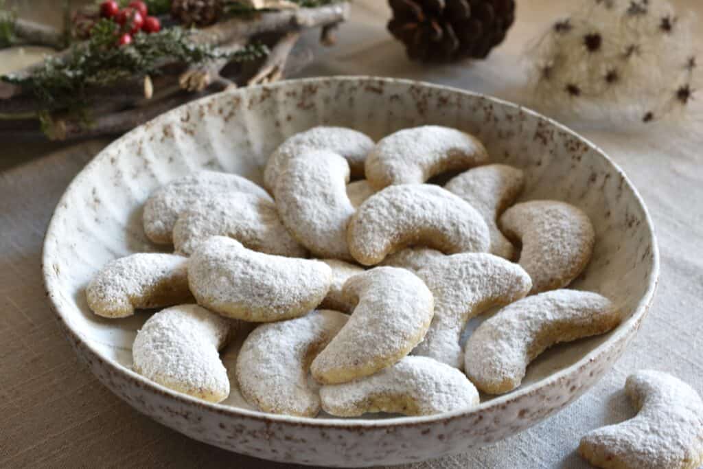 Vegan Vanillekipferl (vanilla crescent cookies) in a bowl.