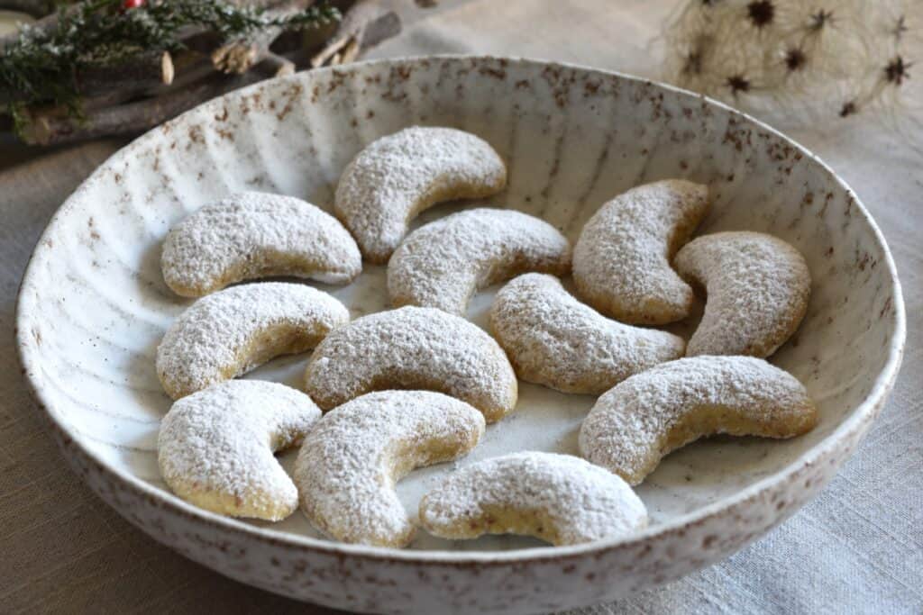 Vegan Vanillekipferl (vanilla crescent cookies) in a bowl.