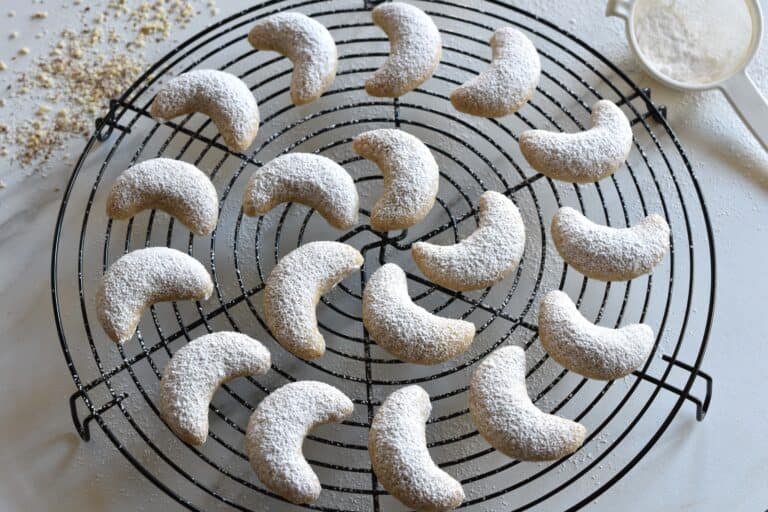 Vegan Vanillekipferl (vanilla crescent cookies) on a cooling rack.