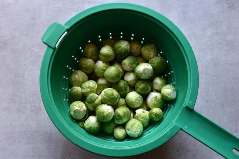 Washed and trimmed Brussels sprouts in a colander.