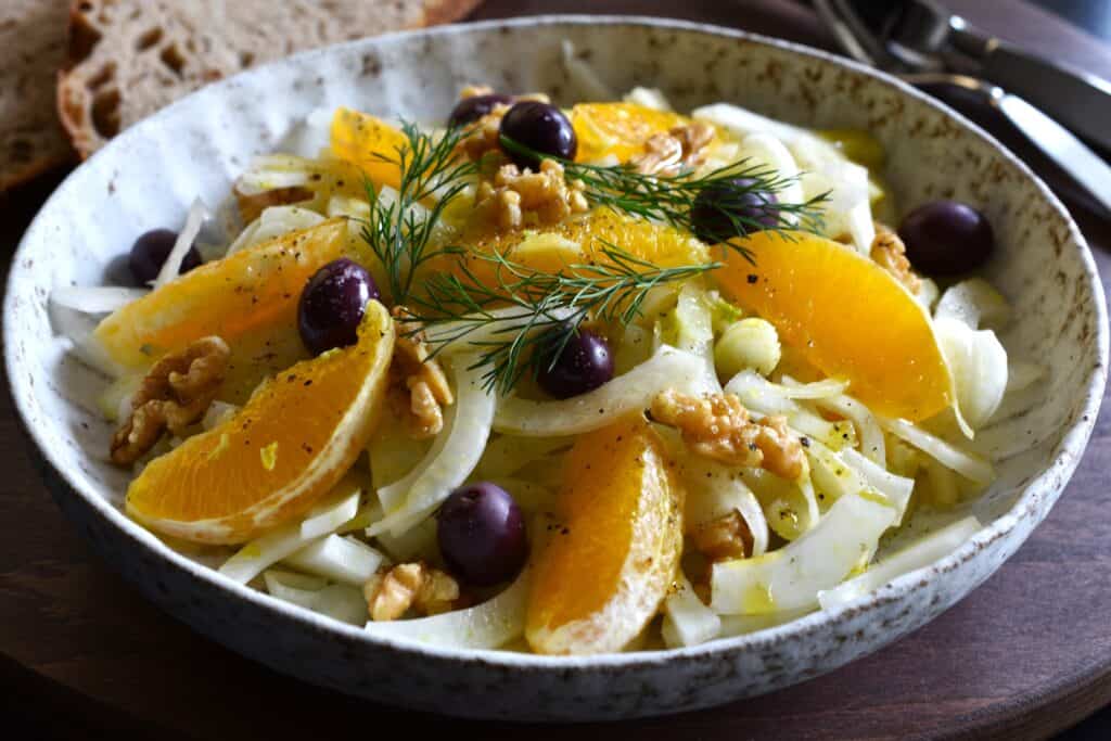 Italian fennel and orange salad with walnuts and black olives (high side view).