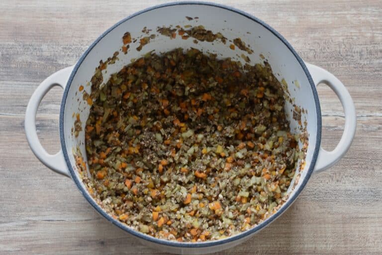 Soffritto and finely chopped mushrooms in a cast iron pan.