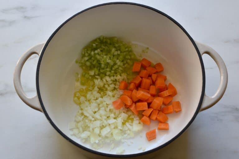 Chopped onion and celery, and diced carrot in a pan with olive oil.