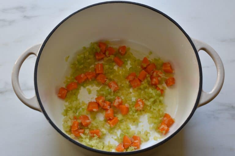 Chopped onion and celery, and diced carrot sautéed in a pan with olive oil.