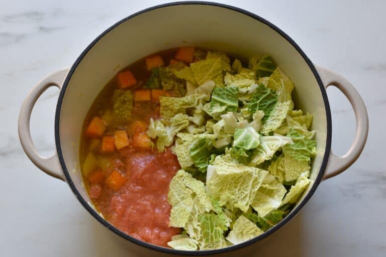 Vegetables and vegetable broth in a pan.