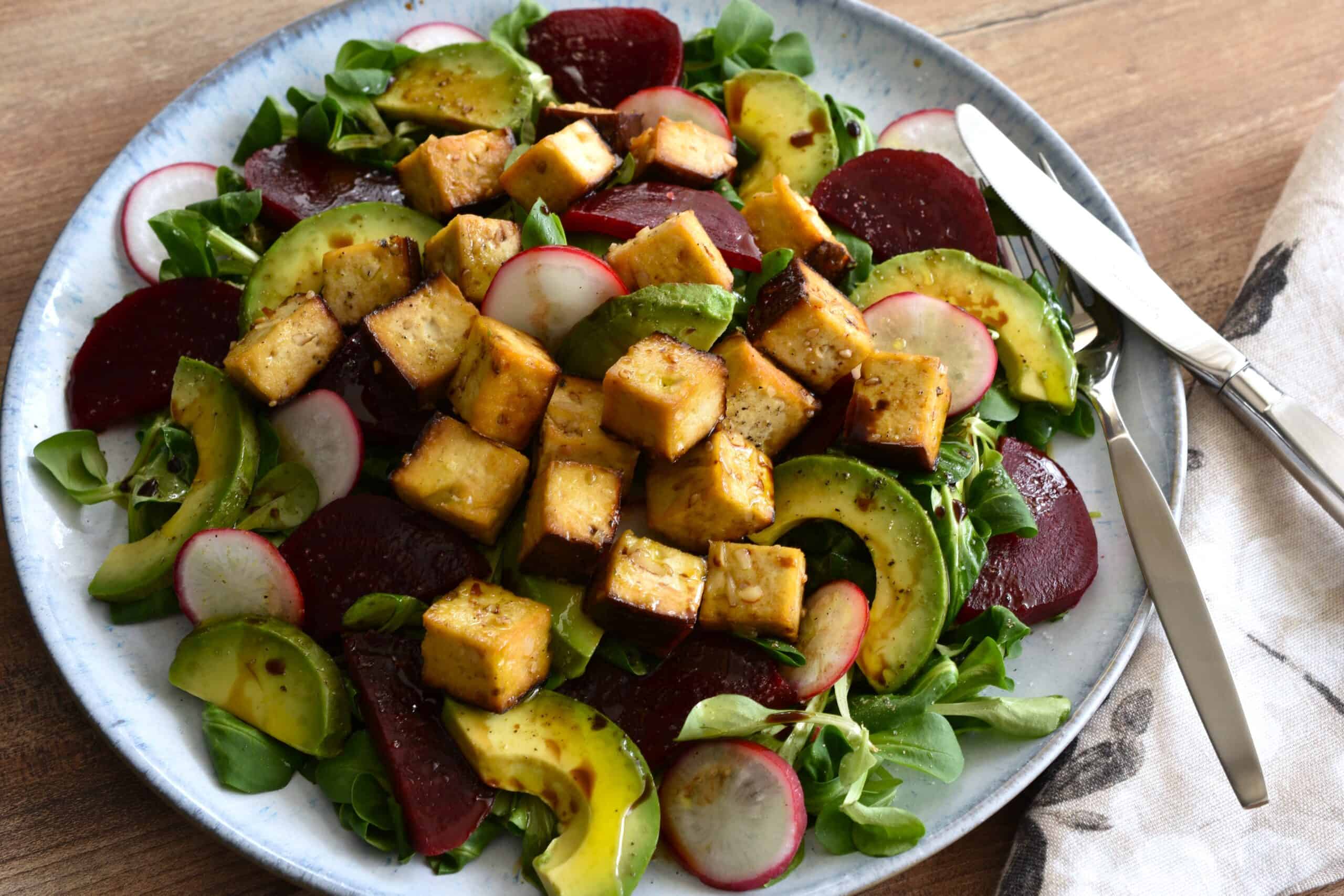 A big plate of lamb's lettuce salad with smoked tofu, beetroot and avocado.