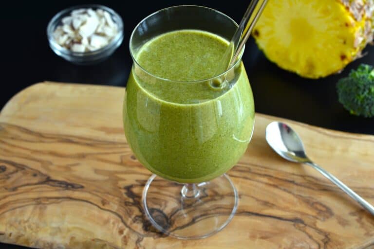 Green pineapple and coconut smoothie in a glass.