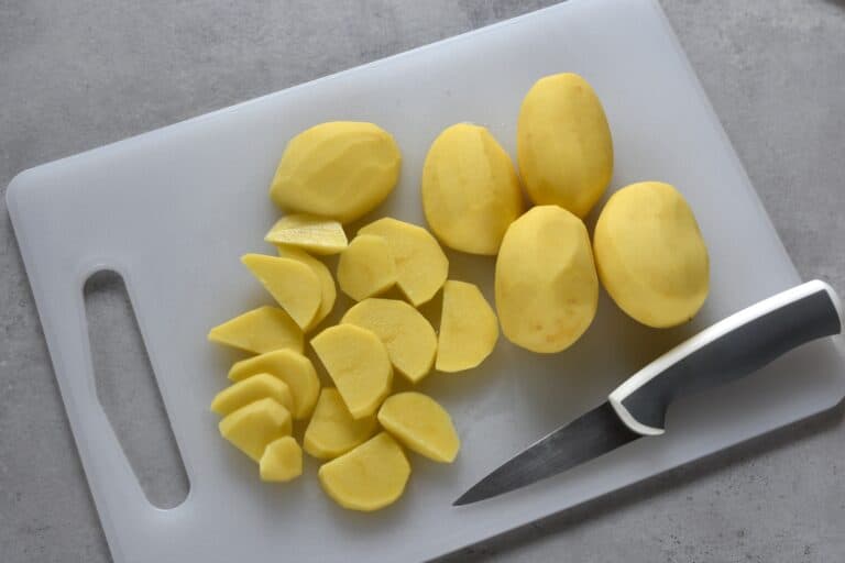 Slicing potatoes on a chopping board.