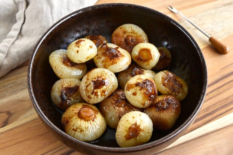 Roasted balsamic borettane onions in a brown serving bowl.