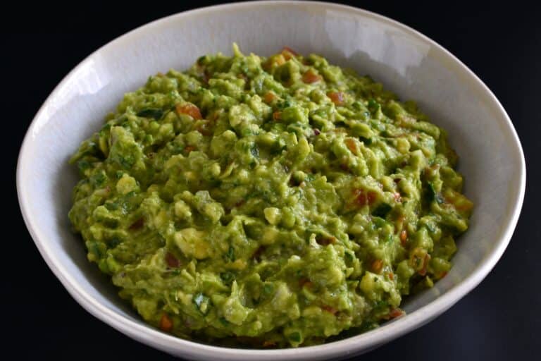 Vegan guacamole in a white bowl.