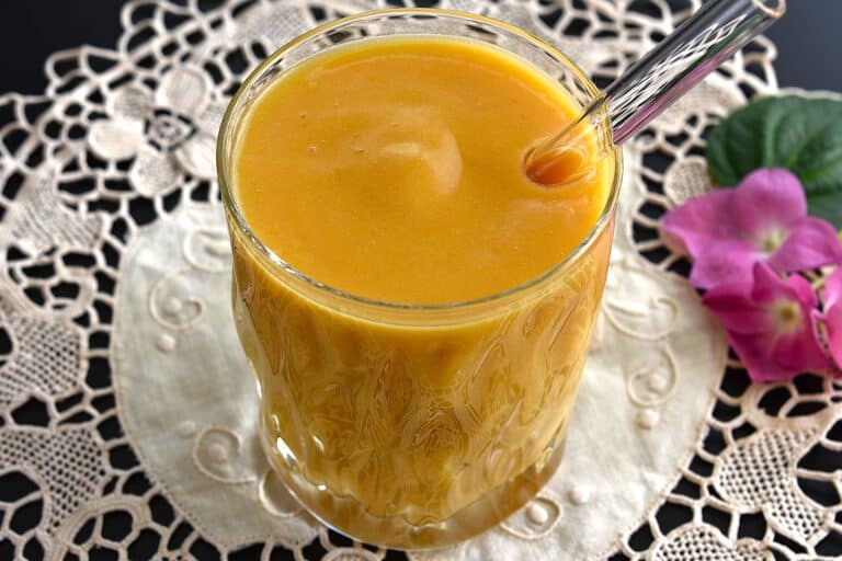 A glass of mango pineapple protein smoothie.