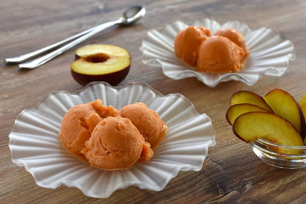 Vegan peach sorbet in glass dishes.