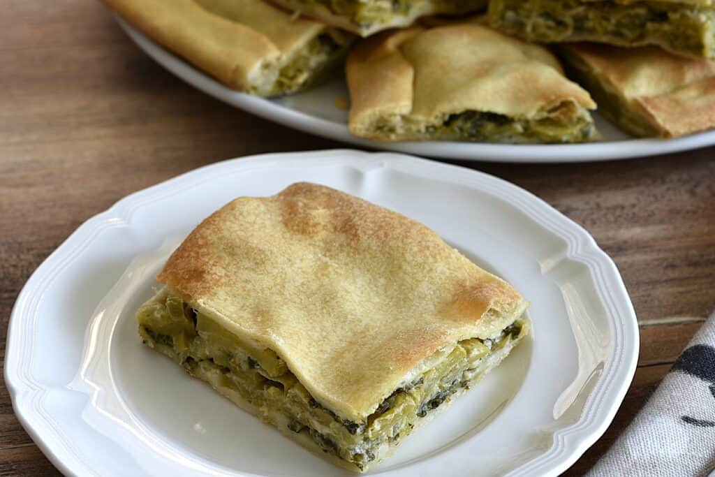 A close-up image of a piece of torta verde ligure on a white plate.