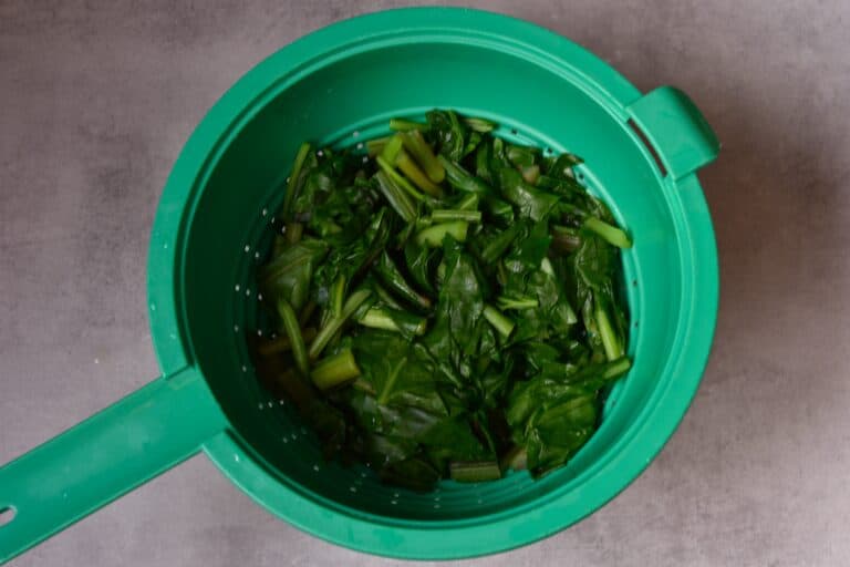 Cooked erbette (perpetual spinach in a colander)