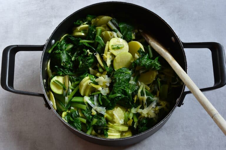 Cooked trombetta,leek, and erbette in a saucepan.