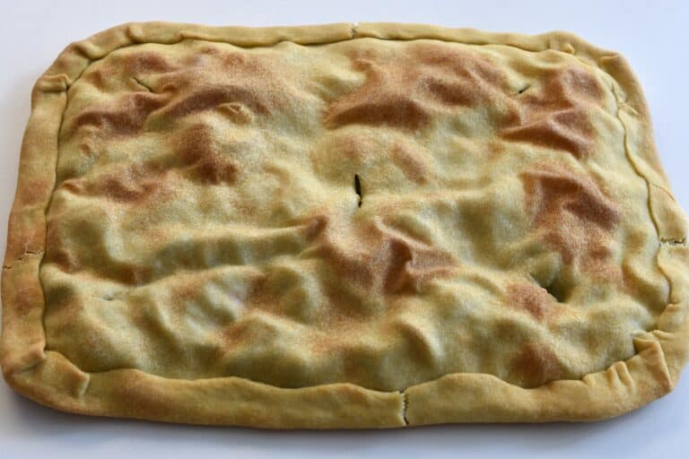 Torta verde after coming out of the oven on a worktop.