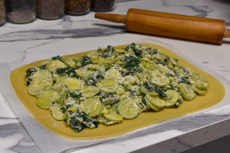 Torta verde filling on a sheet of pastry (pasta matta).