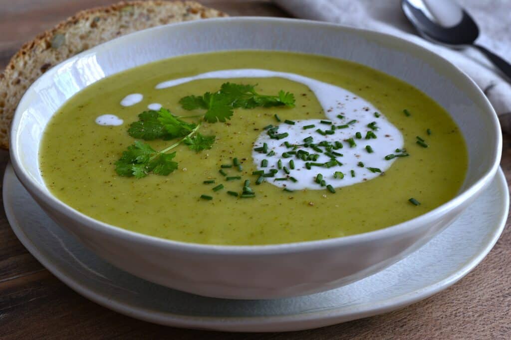 Vegan marrow soup in a white bowl on a table.