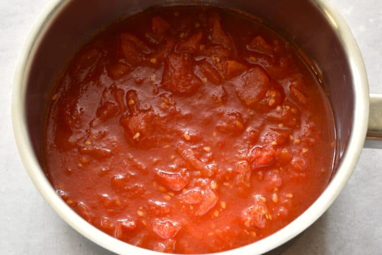 Chopped tomatoes in a sauce pan.