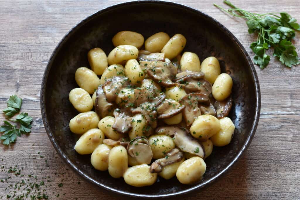 Homemade vegan potato gnocchi with sautéed porcini mushrooms.