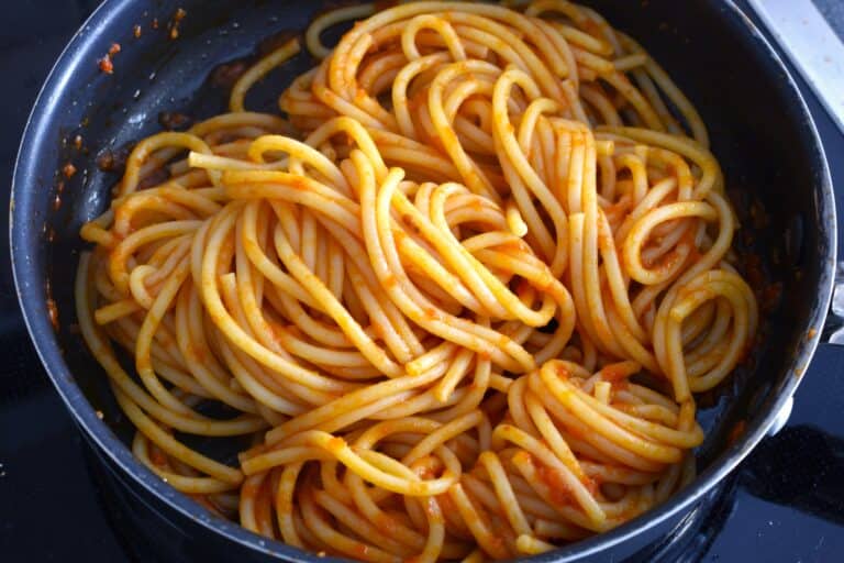 Spaghetti with fresh tomato sauce in a pan.