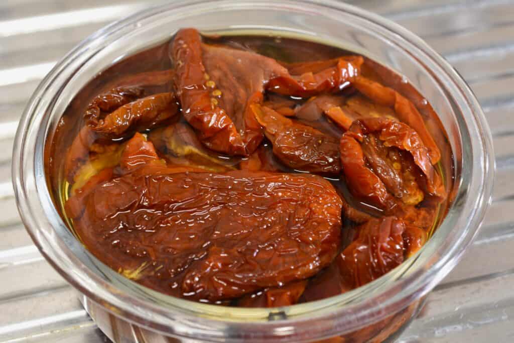 Sundried tomatoes soaking in water and vinegar.