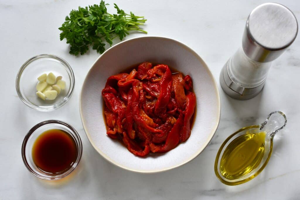 Roasted red pepper strips with their juice, slices of garlic, parsley, sea salt and olive oil.